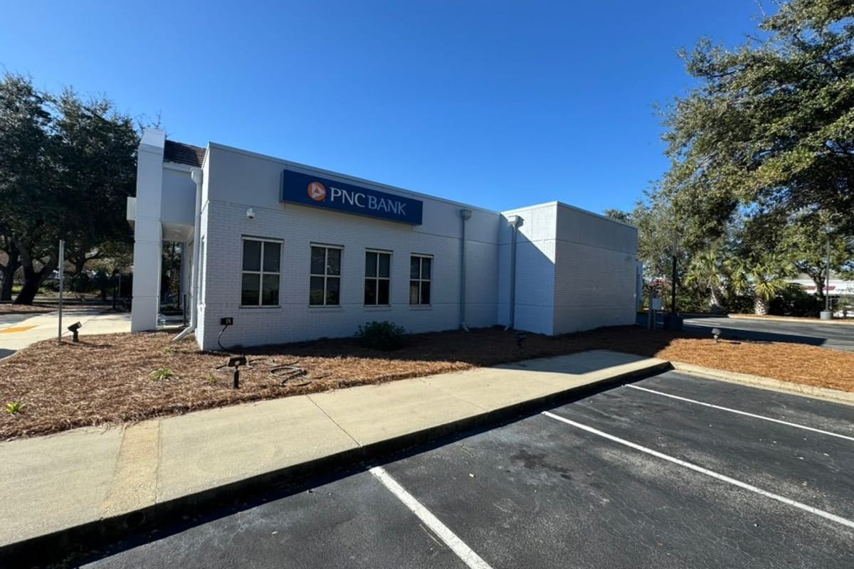 Bank building exterior painted blue-grey with new parking stripes