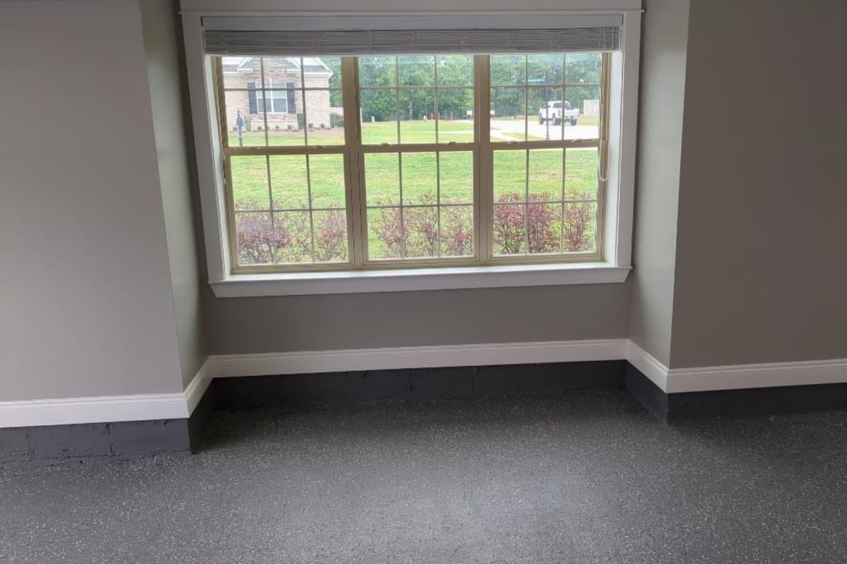 Room with a grey flake epoxy floor and freshly painted walls