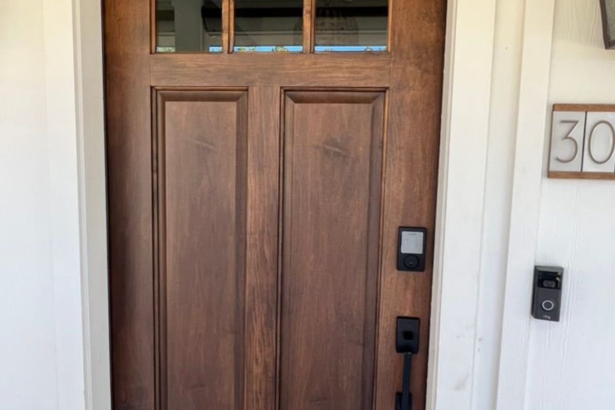 Front door stained a warm walnut and finished with black hardware