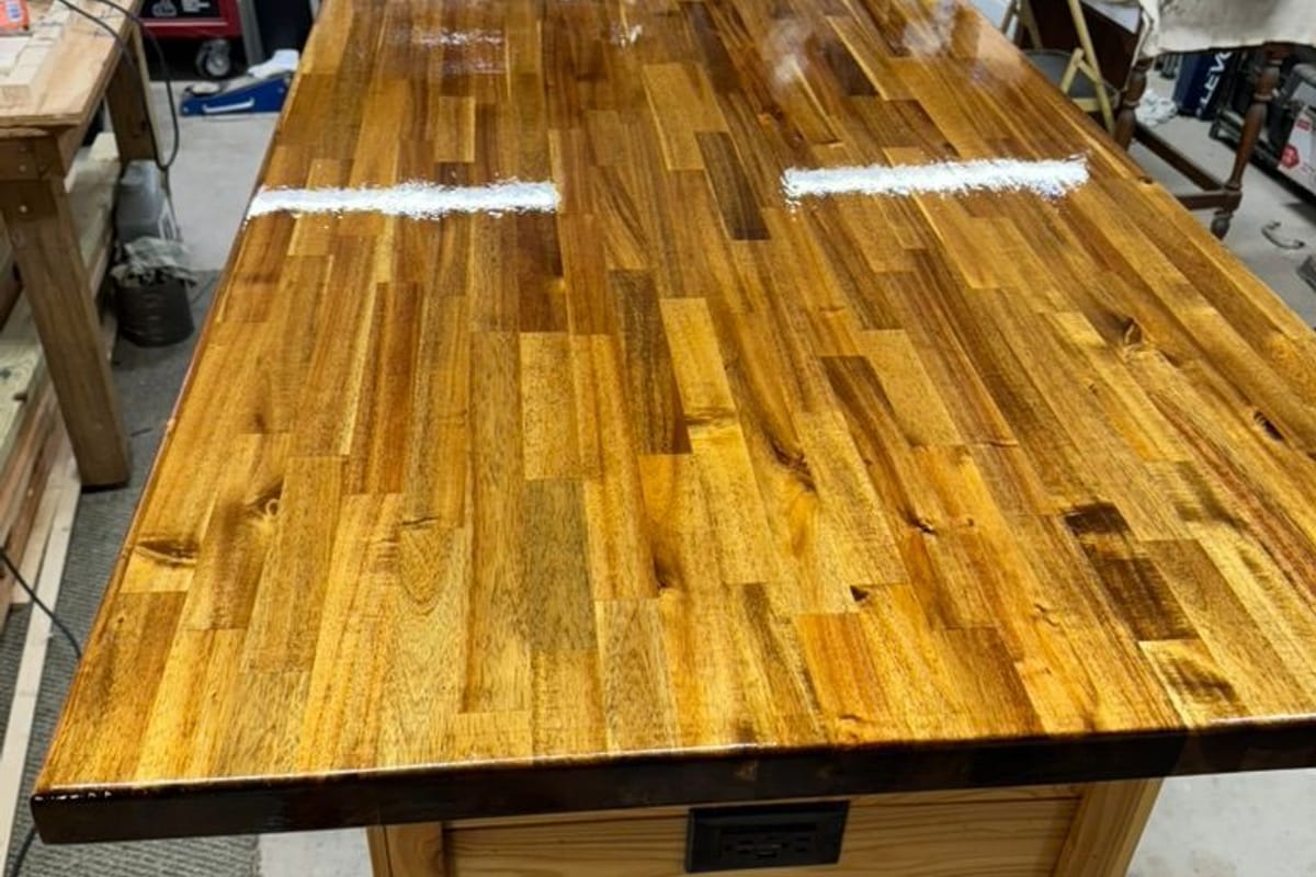 Butcher-block top table sanded and oiled in the workshop